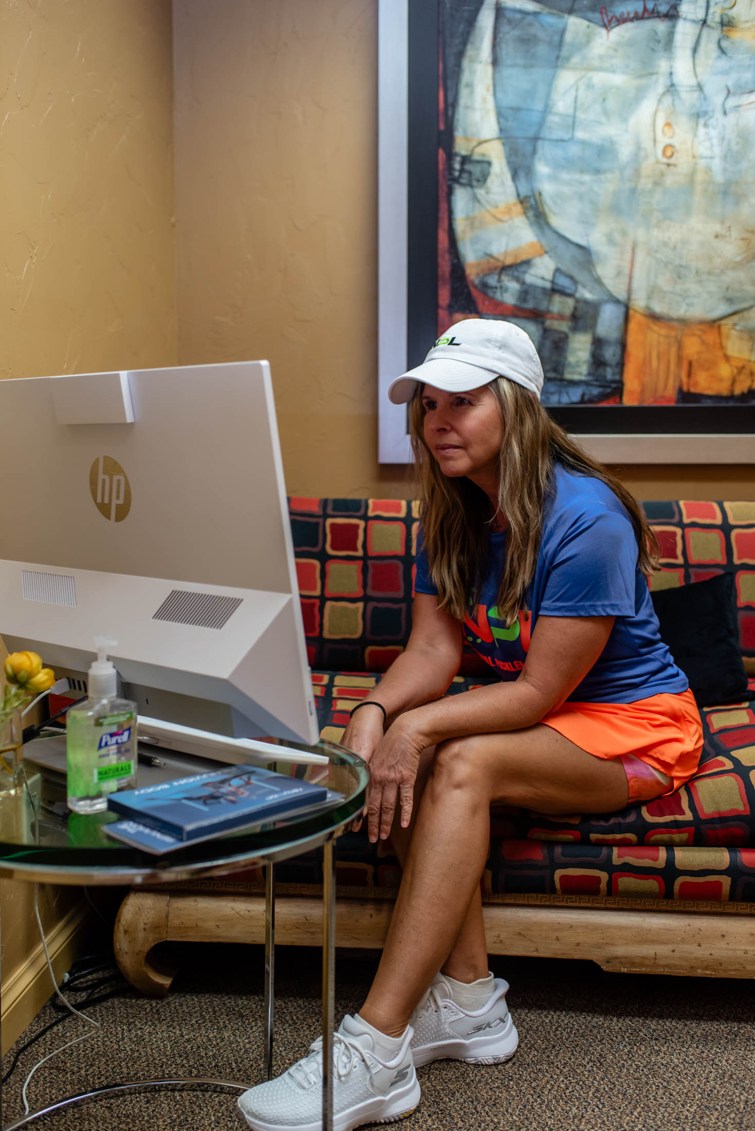 Woman sitting on couch using a computer.